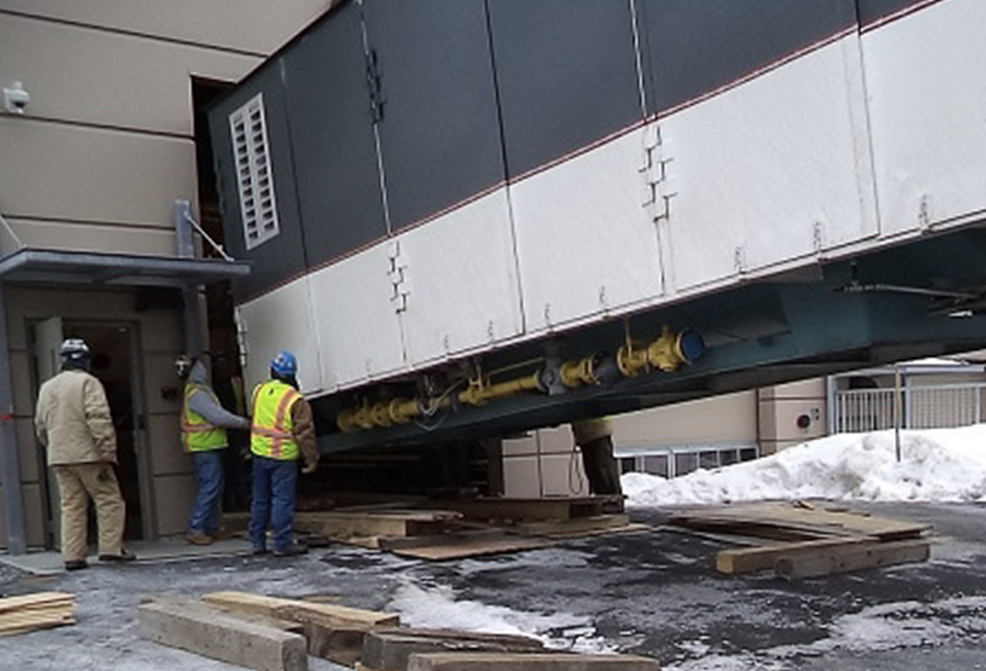 Boiler box being installed by workers